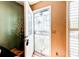 Inviting entryway featuring a vibrant white door with security screen, neutral walls, and a view of the entryway at 9565 W Coal Mine Ave # A, Littleton, CO 80123