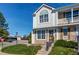 Inviting townhome featuring a well-manicured lawn and a charming, light-filled facade with a delightful architectural details at 9565 W Coal Mine Ave # A, Littleton, CO 80123