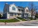 Charming multi-level townhouse with a stone and siding exterior, landscaping, and inviting front entrances at 9565 W Coal Mine Ave # A, Littleton, CO 80123