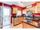 Bright kitchen featuring stainless steel appliances and granite countertops and access to outdoor deck at 9565 W Coal Mine Ave # A, Littleton, CO 80123