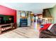 Comfortable living room with a stone fireplace, wood floors, and staircase leading to the upper level at 9565 W Coal Mine Ave # A, Littleton, CO 80123