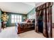 Cozy main bedroom with a beautiful bed, stylish decorations, and plenty of natural light at 9565 W Coal Mine Ave # A, Littleton, CO 80123