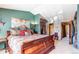 Comfortable main bedroom featuring a large bed with many pillows and a pretty wall decoration at 9565 W Coal Mine Ave # A, Littleton, CO 80123