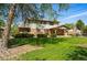 Beautifully landscaped backyard with mature trees and a well-maintained lawn at 1354 S Macon St, Aurora, CO 80012