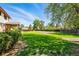 Well-kept backyard with healthy green lawn and a partial view of the home at 1354 S Macon St, Aurora, CO 80012