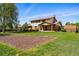Backyard view of a two-story home with a patio and manicured lawn at 1354 S Macon St, Aurora, CO 80012