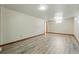 Spacious basement with wood-look flooring and a small window at 1354 S Macon St, Aurora, CO 80012