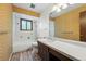 Cozy bathroom with a tile shower-tub, patterned wallpaper, and updated vanity at 1354 S Macon St, Aurora, CO 80012