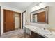 Bathroom sink, vanity, and closet in neutral tones at 1354 S Macon St, Aurora, CO 80012