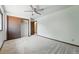 A clean bedroom with a ceiling fan and closet with sliding doors at 1354 S Macon St, Aurora, CO 80012