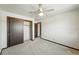 Neutral bedroom with carpet flooring, a ceiling fan, and closet space at 1354 S Macon St, Aurora, CO 80012