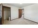 Neutral bedroom with carpet flooring, closet space and an entrance to another room at 1354 S Macon St, Aurora, CO 80012