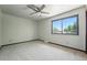 Bright bedroom features natural light from a large window and neutral carpeting at 1354 S Macon St, Aurora, CO 80012