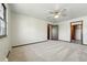 Bedroom with neutral carpeting and trim, and open doorways at 1354 S Macon St, Aurora, CO 80012