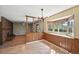 Cozy dining area with wood paneling, bright windows, and stylish lighting at 1354 S Macon St, Aurora, CO 80012
