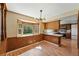 Cozy dining area with wood paneling and bright window offering ample natural light at 1354 S Macon St, Aurora, CO 80012