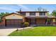 Charming two-story home with brick and vinyl siding, complemented by a well-manicured lawn and mature trees at 1354 S Macon St, Aurora, CO 80012