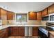 Cozy kitchen featuring wooden cabinets, stainless steel appliances, and ample counter space at 1354 S Macon St, Aurora, CO 80012