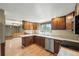 Cozy kitchen with wooden cabinets, stainless steel appliances, and bright natural light at 1354 S Macon St, Aurora, CO 80012