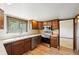 A traditional-style kitchen featuring wooden cabinets, stainless appliances, and laminate flooring at 1354 S Macon St, Aurora, CO 80012