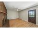 Spacious living room featuring brick fireplace, laminate floors, and convenient back door access at 1354 S Macon St, Aurora, CO 80012