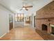 Inviting living room with a brick fireplace, wood laminate flooring, and views to kitchen at 1354 S Macon St, Aurora, CO 80012