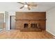 Spacious living room with a brick fireplace, wood laminate floors, and a ceiling fan at 1354 S Macon St, Aurora, CO 80012