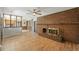 Cozy living room featuring a brick fireplace, wood laminate floors, and natural lighting at 1354 S Macon St, Aurora, CO 80012