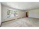 Spacious carpeted living room featuring a large bay window that fills the space with natural light, enhancing its appeal at 1354 S Macon St, Aurora, CO 80012