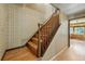 Classic staircase features hardwood steps, stained banister, and patterned wallpaper, adding character to the home's interior at 1354 S Macon St, Aurora, CO 80012