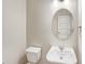 Simple, yet functional half bathroom with pedestal sink and oval mirror at 11267 Central Ct, Broomfield, CO 80021