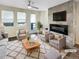 Virtually staged living room with fireplace, wood floors, and access to a deck at 11267 Central Ct, Broomfield, CO 80021