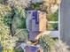 Aerial view of home showcasing roof with solar panels, patio with furniture, landscaped backyard, and mature trees at 3930 S Hillcrest Dr, Denver, CO 80237