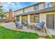 Inviting backyard patio with outdoor furniture and view of the landscaped yard at 3930 S Hillcrest Dr, Denver, CO 80237