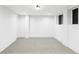 Finished basement with new carpet, neutral paint, and modern lighting at 3930 S Hillcrest Dr, Denver, CO 80237