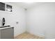 Laundry hookups in the unfinished basement with new vinyl flooring and recessed lighting at 3930 S Hillcrest Dr, Denver, CO 80237