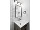 Bathroom featuring a unique tile pattern, dark fixtures, and wood-style vanity at 3930 S Hillcrest Dr, Denver, CO 80237