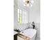 Luxurious bathroom with a freestanding tub, modern lighting, and marble tile at 3930 S Hillcrest Dr, Denver, CO 80237