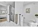 Modern bathroom featuring a glass-enclosed shower and white marble tile flooring at 3930 S Hillcrest Dr, Denver, CO 80237