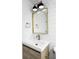 Stylish bathroom featuring a gold mirror, modern vanity, and white subway tile at 3930 S Hillcrest Dr, Denver, CO 80237