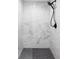 Modern walk-in shower features marble tile and a sleek black shower head at 3930 S Hillcrest Dr, Denver, CO 80237