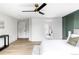 Spacious bedroom featuring an accent wall, ceiling fan, and hardwood floors at 3930 S Hillcrest Dr, Denver, CO 80237