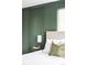 Bedroom detail showing a stylish accent wall and neutral decor at 3930 S Hillcrest Dr, Denver, CO 80237