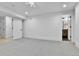 Spacious bedroom boasts neutral carpet and paint, with open doorway to an en suite bathroom at 3930 S Hillcrest Dr, Denver, CO 80237