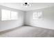 Sunlit bedroom with neutral carpet and large windows at 3930 S Hillcrest Dr, Denver, CO 80237