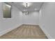 Bright bedroom features a large window letting in ample natural light, complemented by neutral-toned carpet and fresh white walls at 3930 S Hillcrest Dr, Denver, CO 80237
