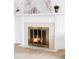 Close up of marble fireplace, white mantle, and glass screen at 3930 S Hillcrest Dr, Denver, CO 80237