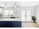 Bright kitchen featuring a large island, white cabinets, and stainless steel appliances at 3930 S Hillcrest Dr, Denver, CO 80237