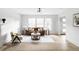 Elegant living room with hardwood floors, large windows, and stylish furniture at 3930 S Hillcrest Dr, Denver, CO 80237