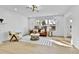 Spacious living room featuring hardwood floors, large windows, and comfortable seating at 3930 S Hillcrest Dr, Denver, CO 80237